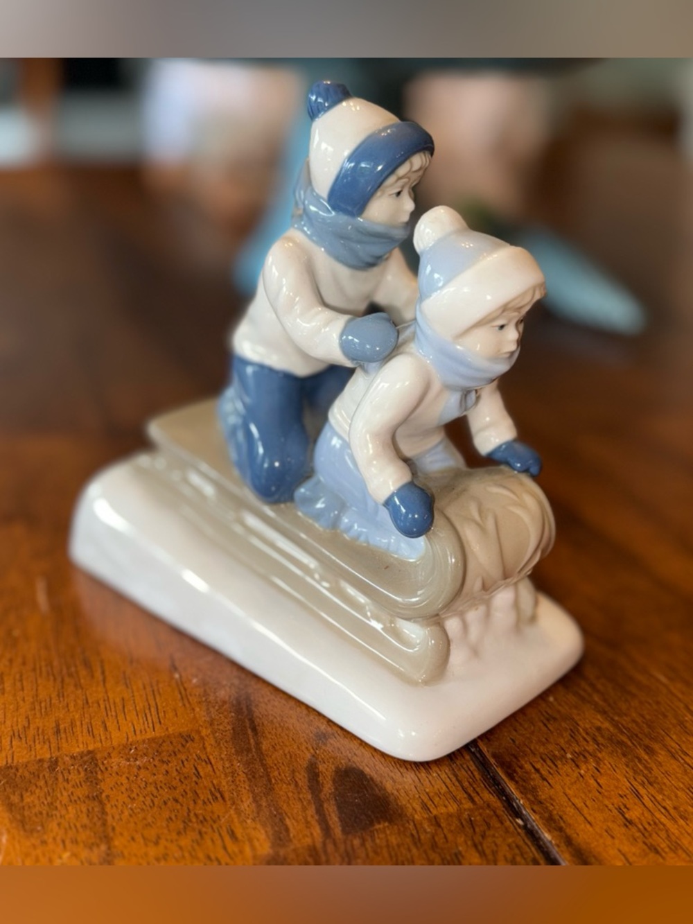 Vintage Porcelain Figurine of Children Sledding Blue White by Paul Sebastian
